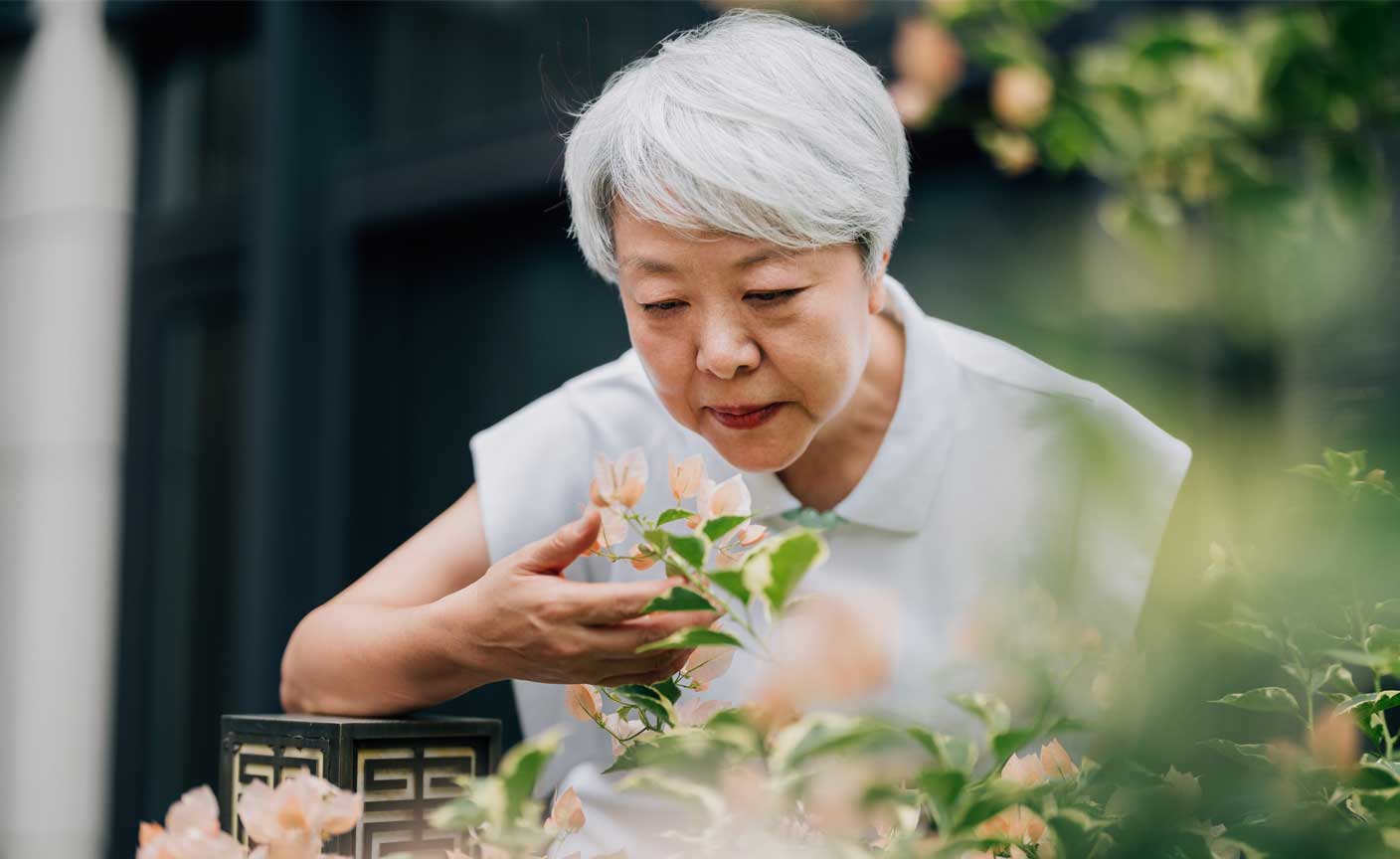 Woman smelling flowers outdoors