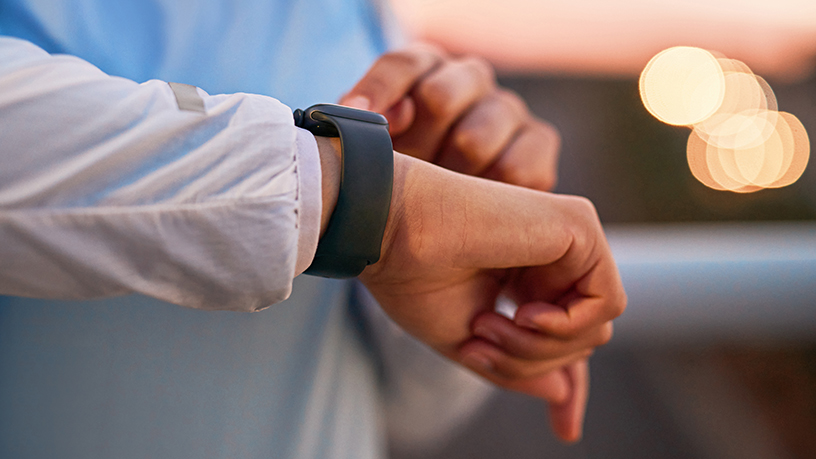 A close up of someone looking at their smart watch.