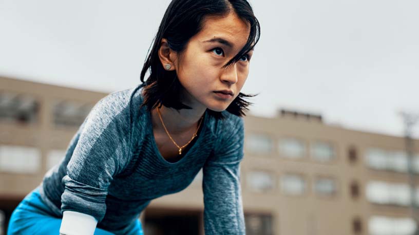 Woman looks up in a determined stance.
