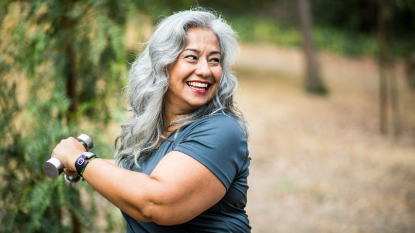 A woman glances over her shoulder and smiles.