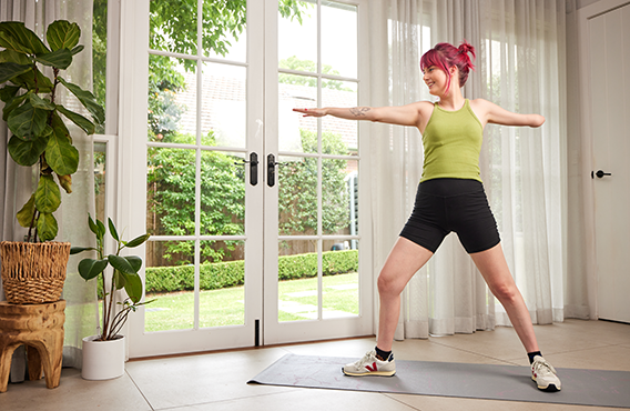 Woman doing yoga in livingroom