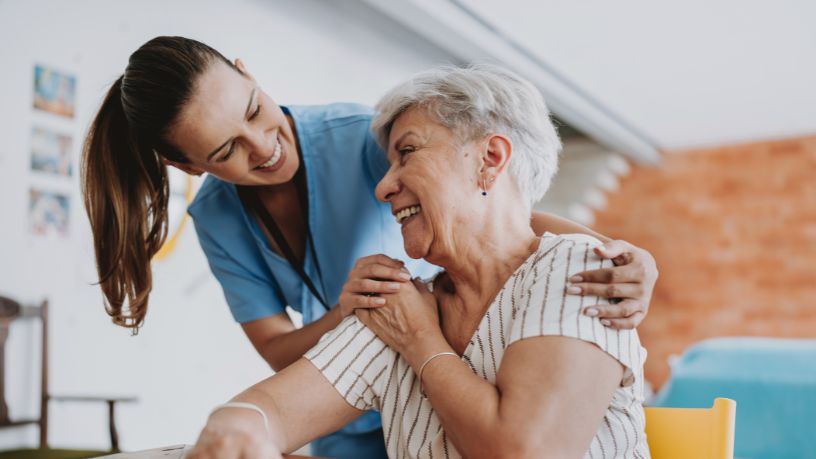 Older women looking up at a member of her care team.