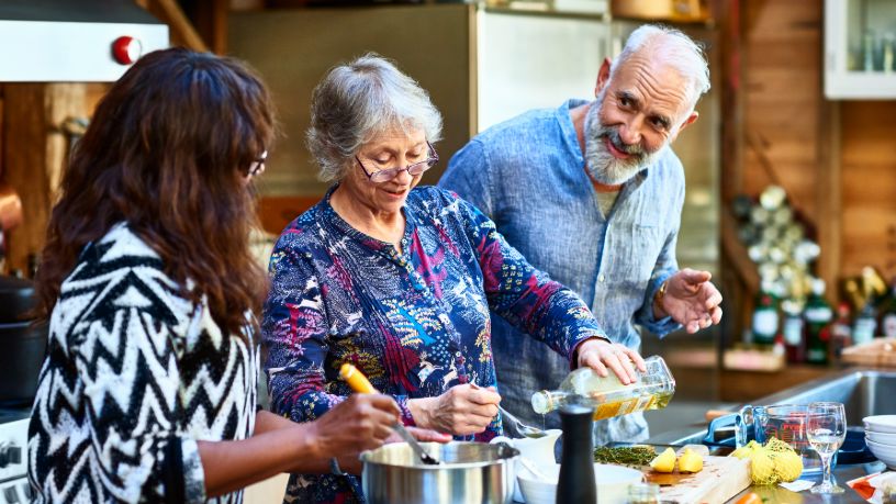 Three people cook together.