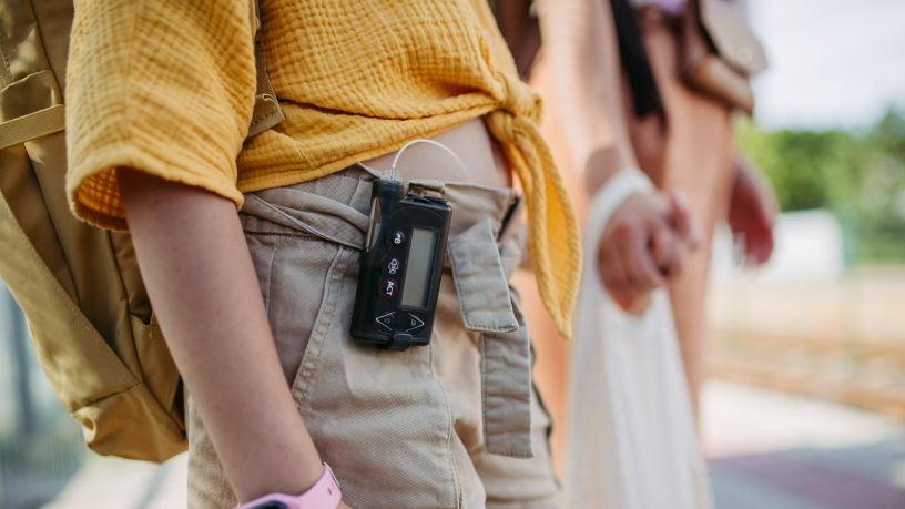 A teenager with an insulin pump clipped to their pants.