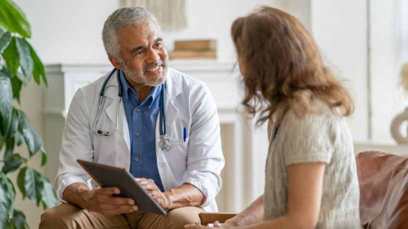 A woman speaks with her doctor.
