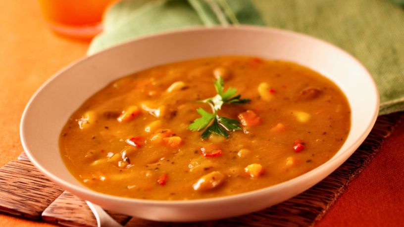 A bowl of Cajun chicken jambalaya rests on a table mat.
