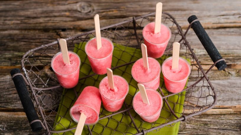 Eight berry good smoothie poles stand in a rustic metal basket.