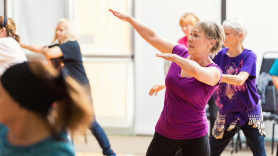 A group of senior people in activewear doing an exercise class